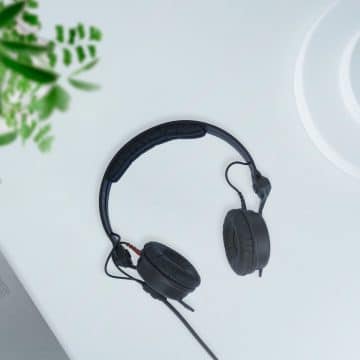 black corded headphones on white table